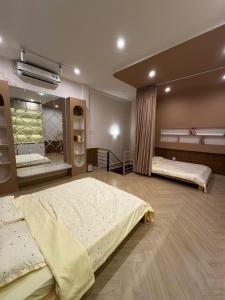 a large room with two beds in it at Gần Homestay - Nha Trang in Nha Trang