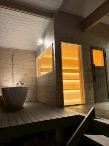 a bathroom with a tub and a window and a door at Second House kukka in Naganohara +13 photos