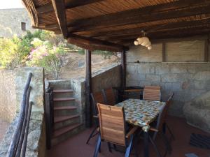 un tavolo e sedie su un patio con tetto di Residence Scala Chiusa a Baja Sardinia