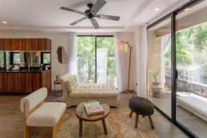 トゥルムにあるArt House Tulum - The Curated Escapeのソファと天井ファンのあるリビングルーム