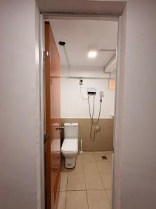 a bathroom with a toilet and a shower at 8-Bed Mixed Dorm, Surf & Social Hostel Siargao in General Luna