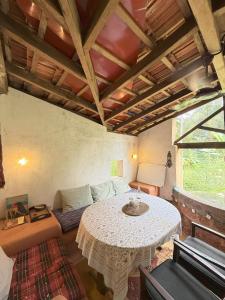 a living room with a table and a couch at Caju Grove - The Big Yellow Goan House in Guirim