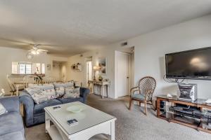 a living room with a couch and a tv at Anchorage II B04 in Myrtle Beach