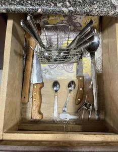 a drawer filled with lots of kitchen utensils at Roma Apartment LXR in Luxor