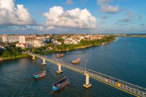 a bridge over a river with boats on it at RiverTown Hoi An Resort & Spa in Hoi An