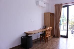 a kitchen with a table and chairs and a balcony at Gạo Homestay-Hue in Hue