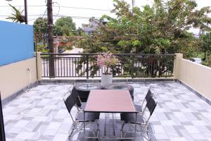 a patio with a table and chairs on a balcony at Gạo Homestay-Hue in Hue