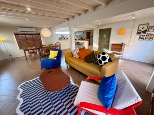 a living room with a couch and a table at City Center, Private Cozy house at Night Bazaar in Chiang Rai