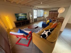 a living room with a couch and a tv at City Center, Private Cozy house at Night Bazaar in Chiang Rai