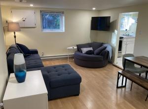 a living room with two couches and a table at Private Suite in Vancouver in Vancouver