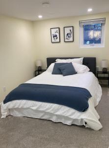 a large bed in a bedroom with two pictures on the wall at Private Suite in Vancouver in Vancouver