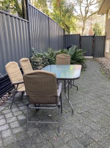 a patio with a table and chairs and a fence at Private Suite in Vancouver in Vancouver