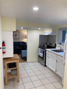 a kitchen with a sink and a stove top oven at Private Suite in Vancouver in Vancouver