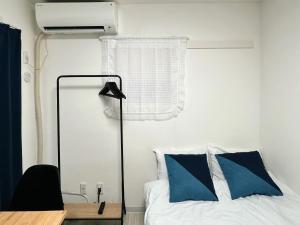 a bedroom with a bed and a desk and a mirror at アークス練馬 in Tokyo