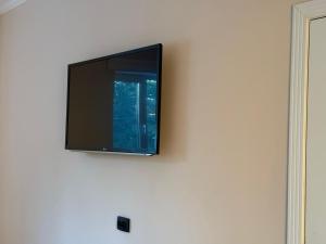 a flat screen tv hanging on a wall at Khan Hostel in Shymkent +12 photos
