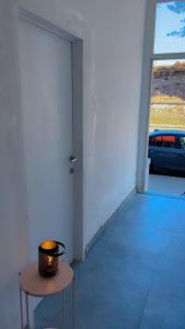 a room with a door and a table with a candle at Coumbis Faye in Brussels