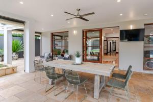 a dining room with a table and chairs at Henley Beach House - Luxury by the Sea in Henley Beach