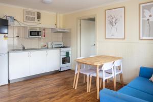 a kitchen and dining room with a table and chairs at Tumby Bay Caravan Park in Tumby Bay +36 photos