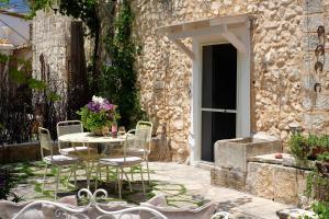 a patio with a table and chairs in front of a building at Masseria Pagliamonte Ortensia in San Vito dei Normanni