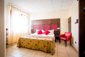 Rúm í herbergi á Piccolo Hotel Nogara