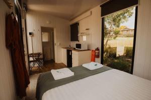 a bedroom with a bed and a large window at Monto Magic by Tiny Away in Monto