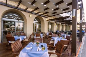 a restaurant with blue tables and chairs in a building at Ibiscus Hotel in Rhodes Town