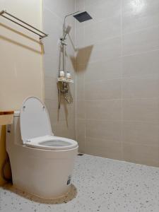 a bathroom with a toilet with the lid up at Tamarind Pool Villa Kohlarn in Ko Larn