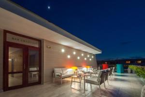 a patio with a table and chairs on a building at Mercury Hotel- All Inclusive in Sunny Beach