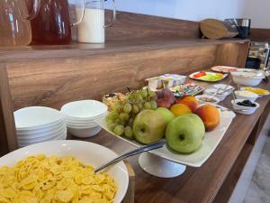a table topped with plates of fruit and chips at Horizon Hotel, Yerevan in Yerevan