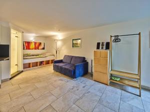 a living room with a couch and a bed at Gemütliche Wohnung in Hellenthal in Hellenthal