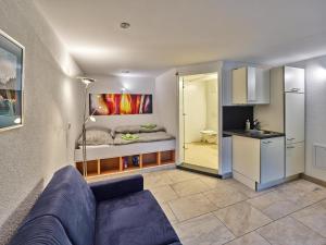 a living room with a couch and a kitchen at Gemütliche Wohnung in Hellenthal in Hellenthal