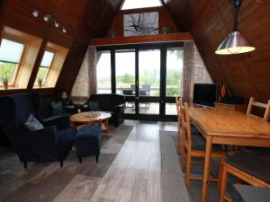 a living room with a couch and a table at Ferienhaus mit Terrasse, Haustierfrei in Clausthal-Zellerfeld