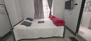 a small bed in a room with a window at Harry's Homestay in Shillong
