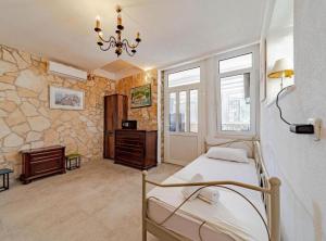 a bedroom with a bed in a room with stone walls at Natur Olive House Ston in Ston