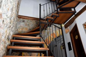 a staircase in a house with wooden railings at La Casa del Geko in Cefalù