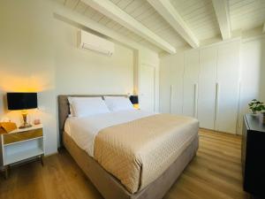 a bedroom with a large bed and a night stand at The Lotus Valpolicella in SantʼAmbrogio di Valpolicella