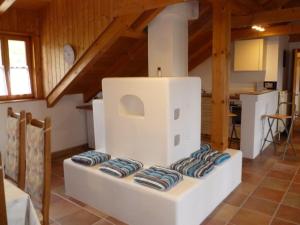 a living room with a white room with blue cushions at Ferienwohnung zum Forsthaus mit Sauna in Oberviechtach
