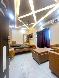 a large room with a bed and a couch at Hasrat Residency in Jagādhri +30 photos