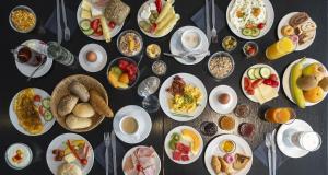 a table with many plates of food on it at PLAZA Premium Salzburg in Salzburg +51 photos