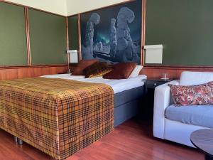 a hotel room with two beds and a couch at Hotel Royal Ruka in Ruka