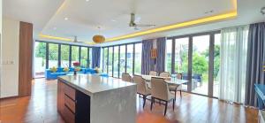 a living room with a kitchen and a dining room at Ocean Villas Da Nang in Danang +55 photos