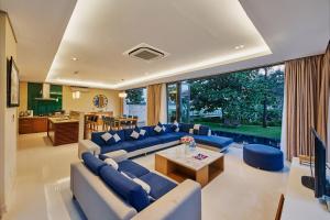 a large living room with blue couches and a table at Ocean Villas Da Nang in Danang
