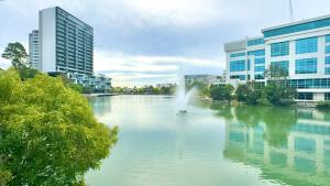 a river in the middle of a city with buildings at Norwest business park in Baulkham Hills