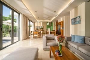 a living room with a couch and a table at Ocean Villas Da Nang in Danang