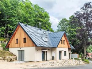 a metal roof on a house with trees in the background at Apartmány U Buku in Jablonec nad Nisou
