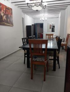 a dining room with a black table and chairs at Casa rural Ismael in El Acebrón +10 photos