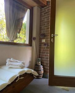 a room with a window and a bed with towels on it at Il nocciòlo di Daisy in Graglia +39 photos