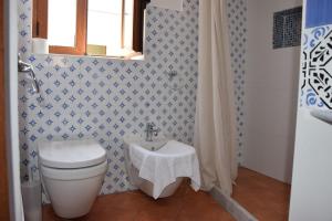 a bathroom with a toilet and a sink at La Casa del Geko in Cefalù