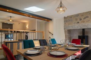 a dining room with a wooden table and chairs at Gîte de recoules in Recoules-dʼAubrac
