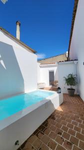 a swimming pool in the backyard of a house at Casa das Andorinhas-Alentejo in Vidigueira